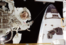 Astronaut John Herrington Completes Spacewalk Mission – NASA An astronaut in a white spacesuit appears on the left side of the image near a part. On the right in the back is part of the space shuttle Endeavour.