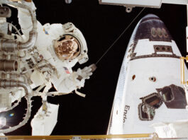 Astronaut John Herrington Completes Spacewalk Mission – NASA An astronaut in a white spacesuit appears on the left side of the image near a part. On the right in the back is part of the space shuttle Endeavour.