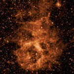 NASA’s SPHEREx Telescope Starts Full-Sky Imaging Infrared image of a glowing orange dust cloud in space, surrounded by a dense field of stars against a dark background, captured by NASA’s SPHEREx mission.