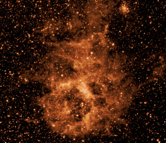 NASA’s SPHEREx Telescope Starts Full-Sky Imaging Infrared image of a glowing orange dust cloud in space, surrounded by a dense field of stars against a dark background, captured by NASA’s SPHEREx mission.