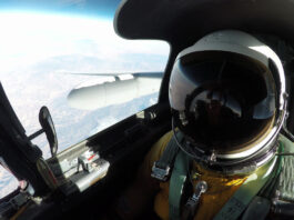 NASA’s Mineral Mapping Tech Takes Flight Over Western U.S. A high-angle, eye-level shot from inside the cockpit of an ER-2 aircraft shows a pilot in a full pressure suit and helmet, with the right wing of the plane and the Earth