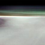NASA Explores Fog-Covered Martian Volcano A black mountain peak shows through water ice clouds on Mars. Just above the clouds is the hazy green Martian atmosphere.