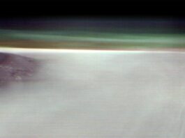 NASA Explores Fog-Covered Martian Volcano A black mountain peak shows through water ice clouds on Mars. Just above the clouds is the hazy green Martian atmosphere.