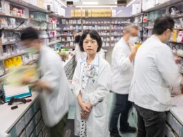 Taiwan Hospital Uses AI to Ease Workload for Medical Staff A group of people in a pharmacy