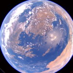 NASA Tests New Solar Array Technology on Pathfinder Spacecraft View of Earth from orbit, appearing as a globe, fully illuminated with sunlight.