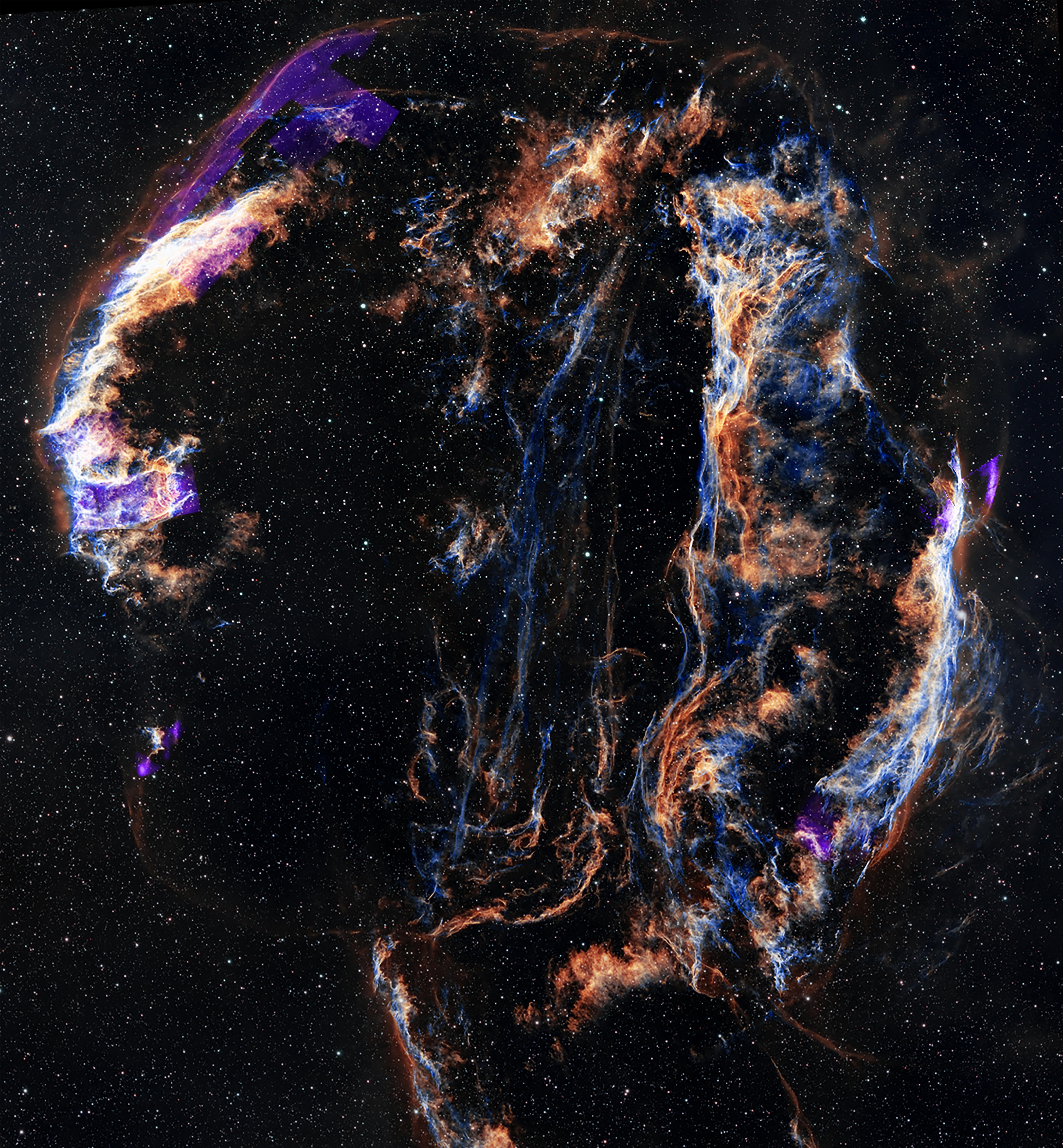 The remnant resembles a wispy cloud in oranges, blues, purples, and whites, shaped like a backwards letter C. The remnant is set against a backdrop of scattered stars.