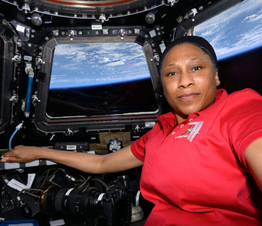 NASA Announces Retirement of Astronaut Jeanette Epps A black woman in a red shirt poses in the International Space Station cupola with the Earth pictured behind her.