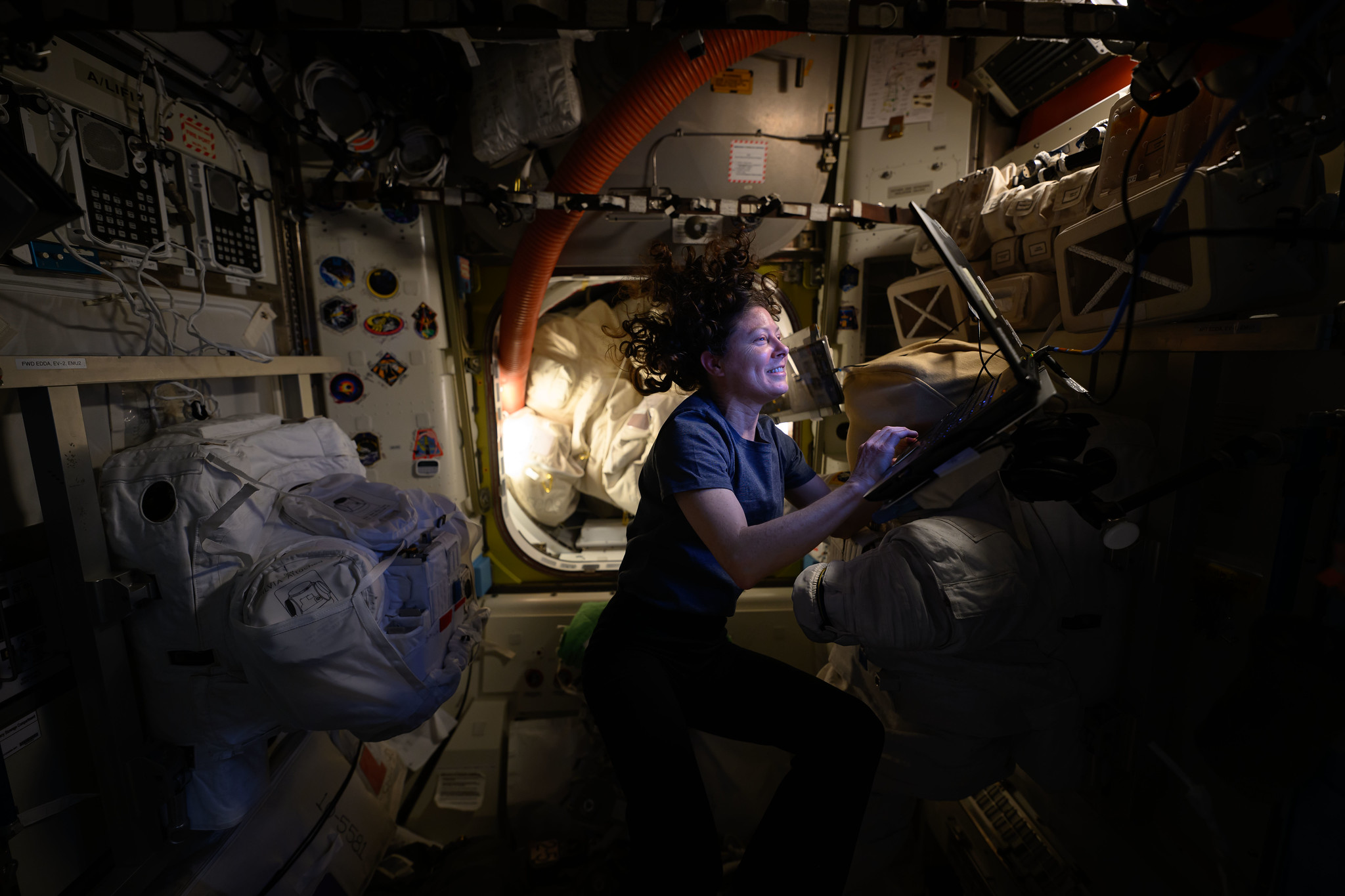 54004850230 4bc5528571 k.jpg NASA astronaut Tracy C. Dyson, with floating hair and lit with the glow of a small lamp, smiles as she works at a computer station aboard the International Space Station.
