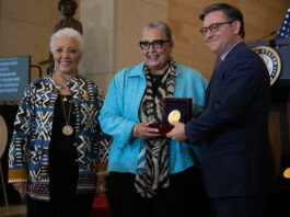 NASA Celebrates Unsung Heroes Two Black women and a white man face slightly left as they pose for a photo. The man and the woman in the middle hold a box containing a Congressional Gold Medal.