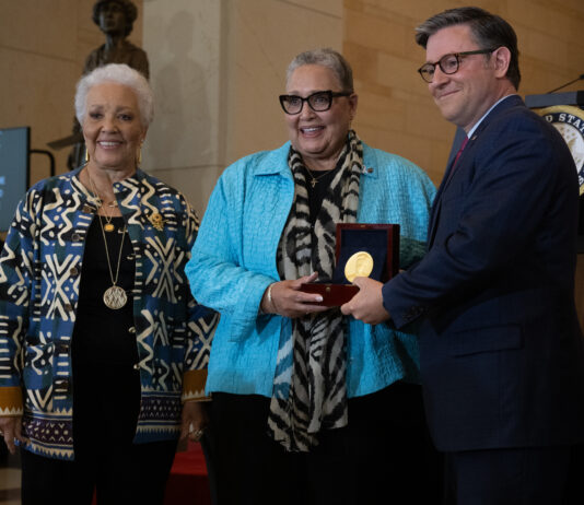 NASA Celebrates Unsung Heroes Two Black women and a white man face slightly left as they pose for a photo. The man and the woman in the middle hold a box containing a Congressional Gold Medal.