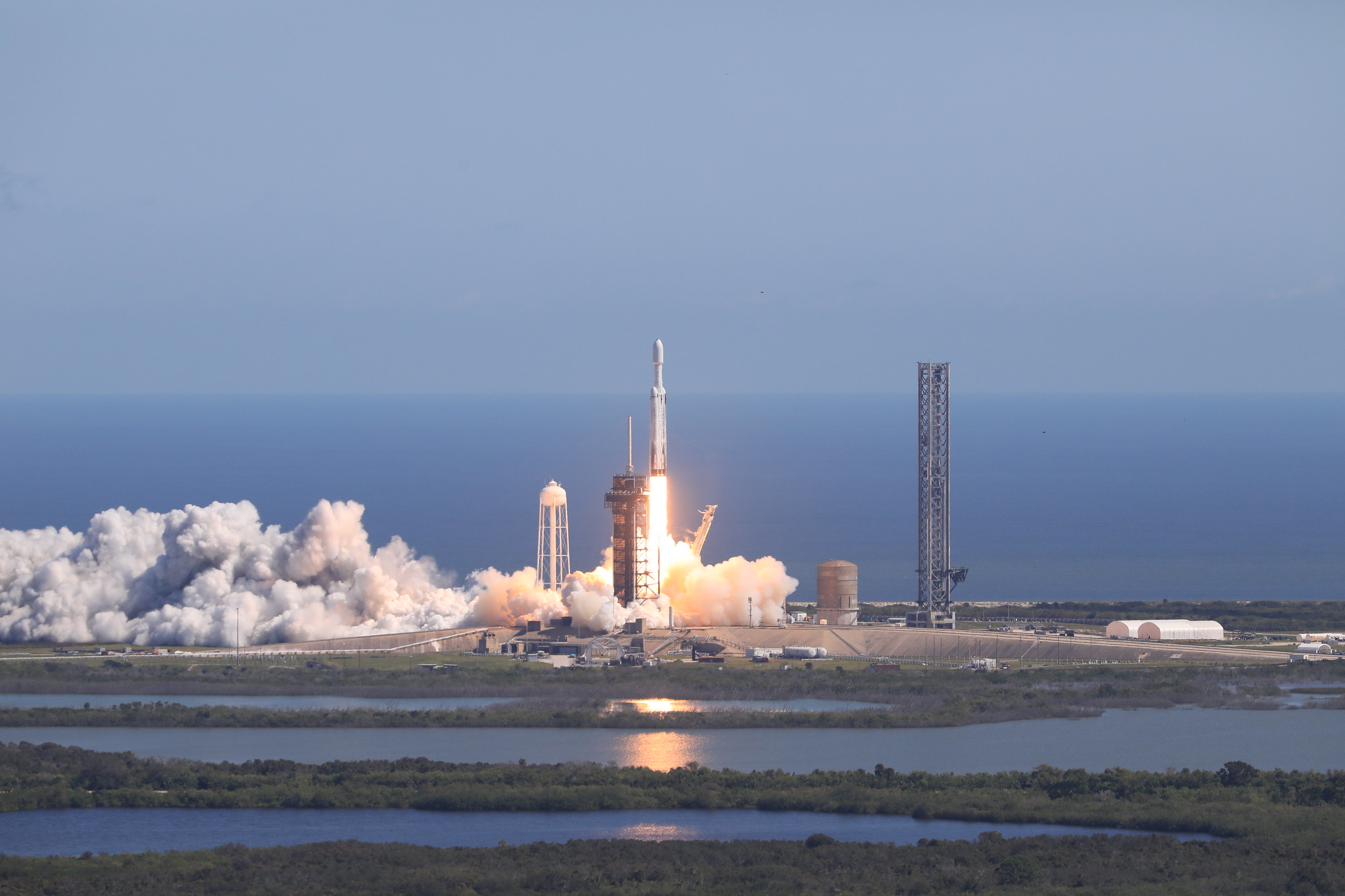 54067151504 46075ee405 k.jpg A SpaceX Falcon Heavy rocket carrying NASA’s Europa Clipper spacecraft launches off the coast of Florida, with blue skies and ocean in the background.