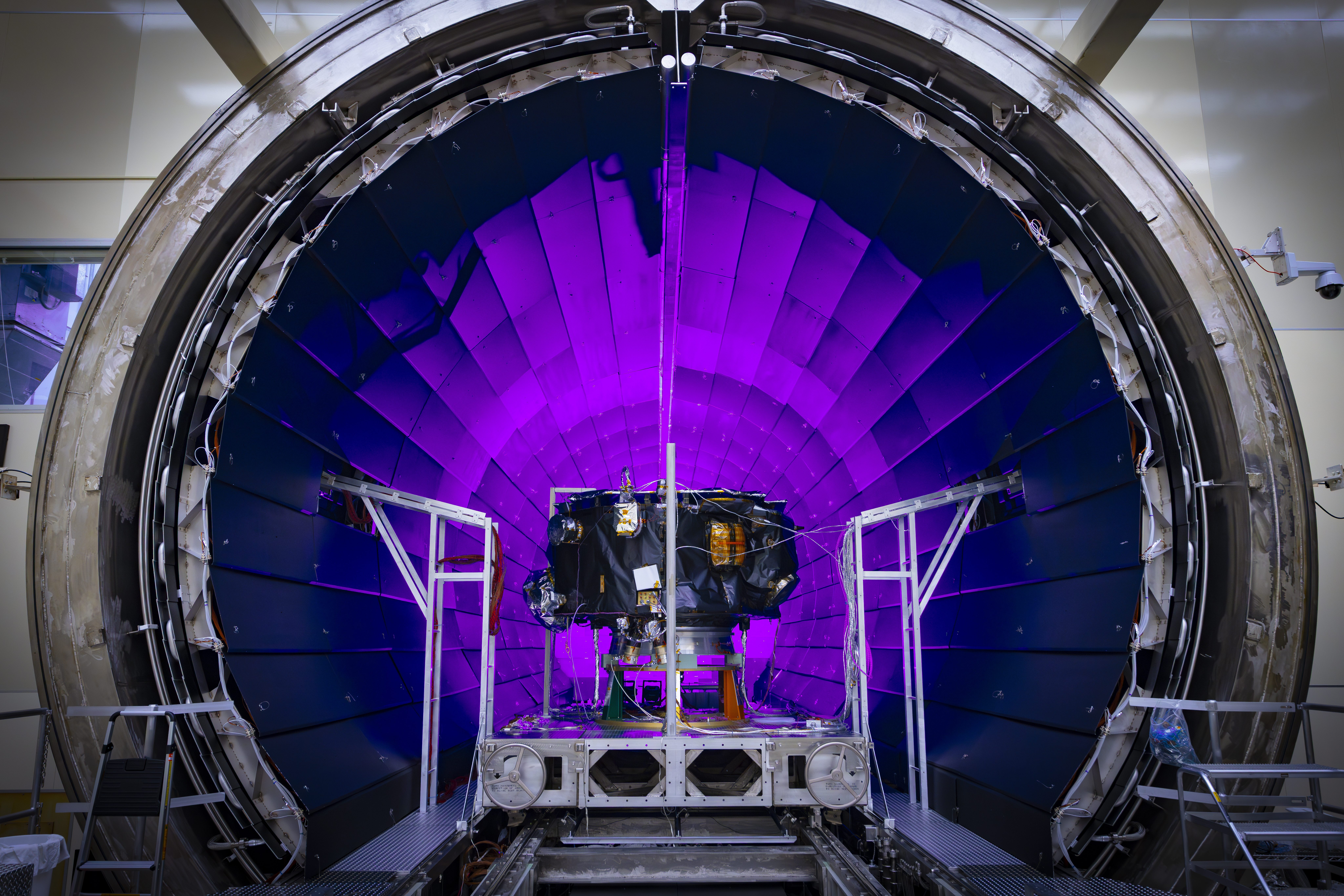 54445421160 48ee2acb22 o.jpg A tunnel dramatically lit in violet light dominates the photo. In front of it, a small spacecraft is on a track.