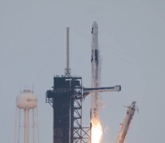 NASA’s Crew-11 Successfully Heads to International Space Station A rocket lifts off from the launchpad, leaving a trail of flames and plumes of vapor in its wake. A white structure and the black gantry can be seen on the left. On the right, a white arm falls away. The photo is taken from a distance.