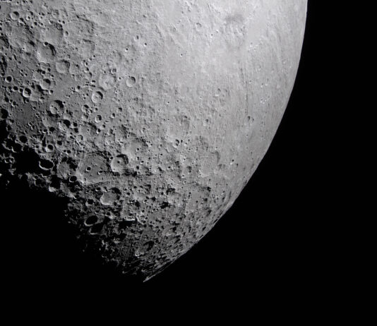 NASA Explores New Frontiers in Light Research Part of the Moon stands out against the blackness of space. Its surface is marked with many craters of different sizes. The craters are mostly on the left and bottom. The upper right portion of the Moon
