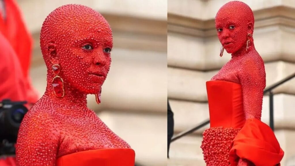 Doja Cat arrived at the Schiaparelli Paris Fashion Week Show doused in red paint and 30,000 Swarovski Crystals