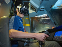 NASA Experiments with Mixed Reality in Vertical Motion Simulator A pilot, Damien Hischier, of the National Test Pilot School dons virtual reality goggles inside a Virtual Motion Simulator at NASA