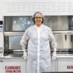 Andrea Harrington’s Leadership Advances Lunar Exploration Efforts – NASA A woman dressed in a white cleanroom suit in a curation laboratory.