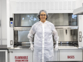 Andrea Harrington’s Leadership Advances Lunar Exploration Efforts – NASA A woman dressed in a white cleanroom suit in a curation laboratory.