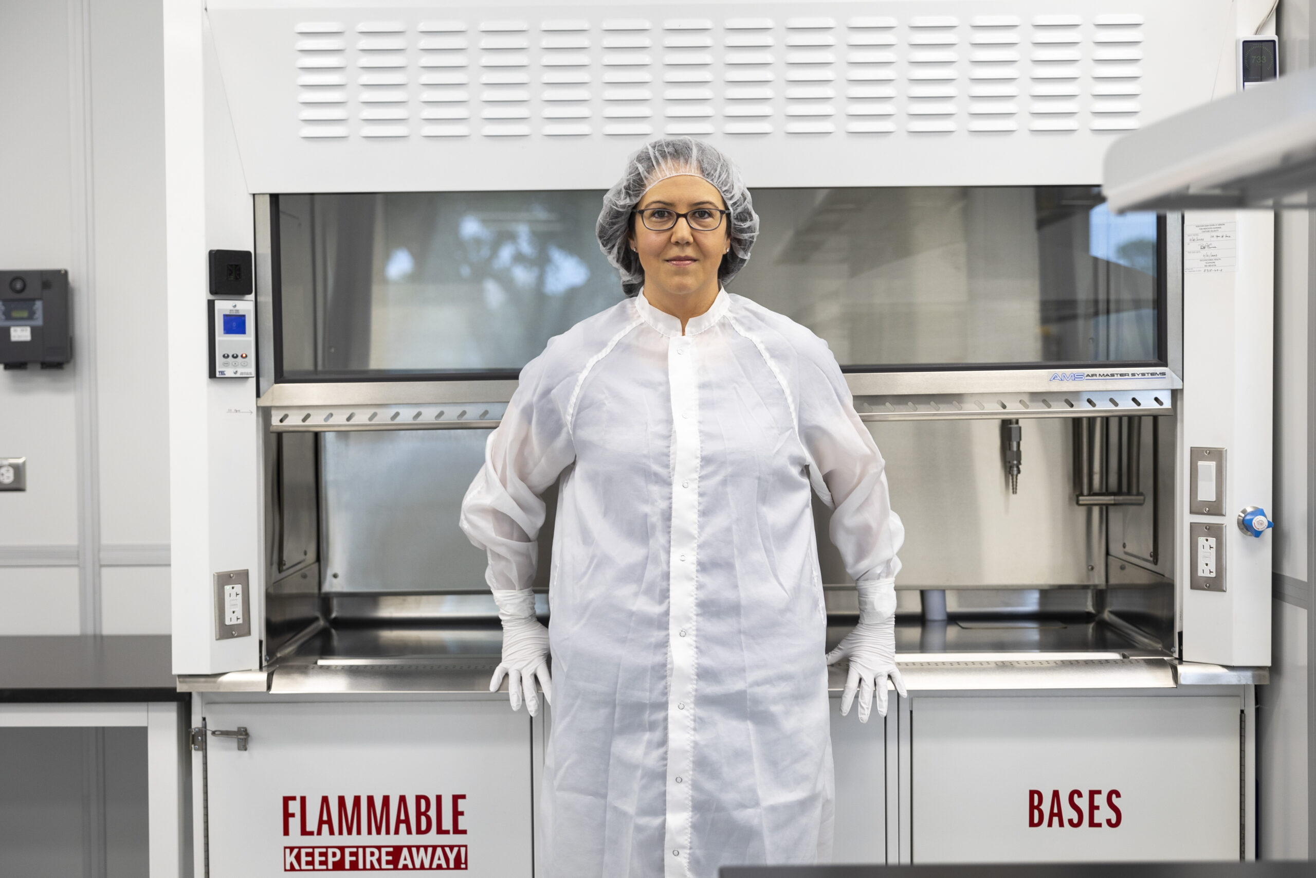 adharrington ac lab.jpg A woman dressed in a white cleanroom suit in a curation laboratory.