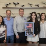 SoCal Student Awarded NASA Scholarship A man presents an award to a woman. Her family is also pictured.