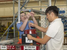 NASA Tests Innovative Wing Concept for Improved Efficiency Two men prepare a wing test article for obtaining vibration data.