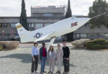 NASA Internships Propel Career Growth Students pose side-by-side in front of a static aircraft display in front of a building at NASA Armstrong. The students are wearing professional clothes and sneakers.