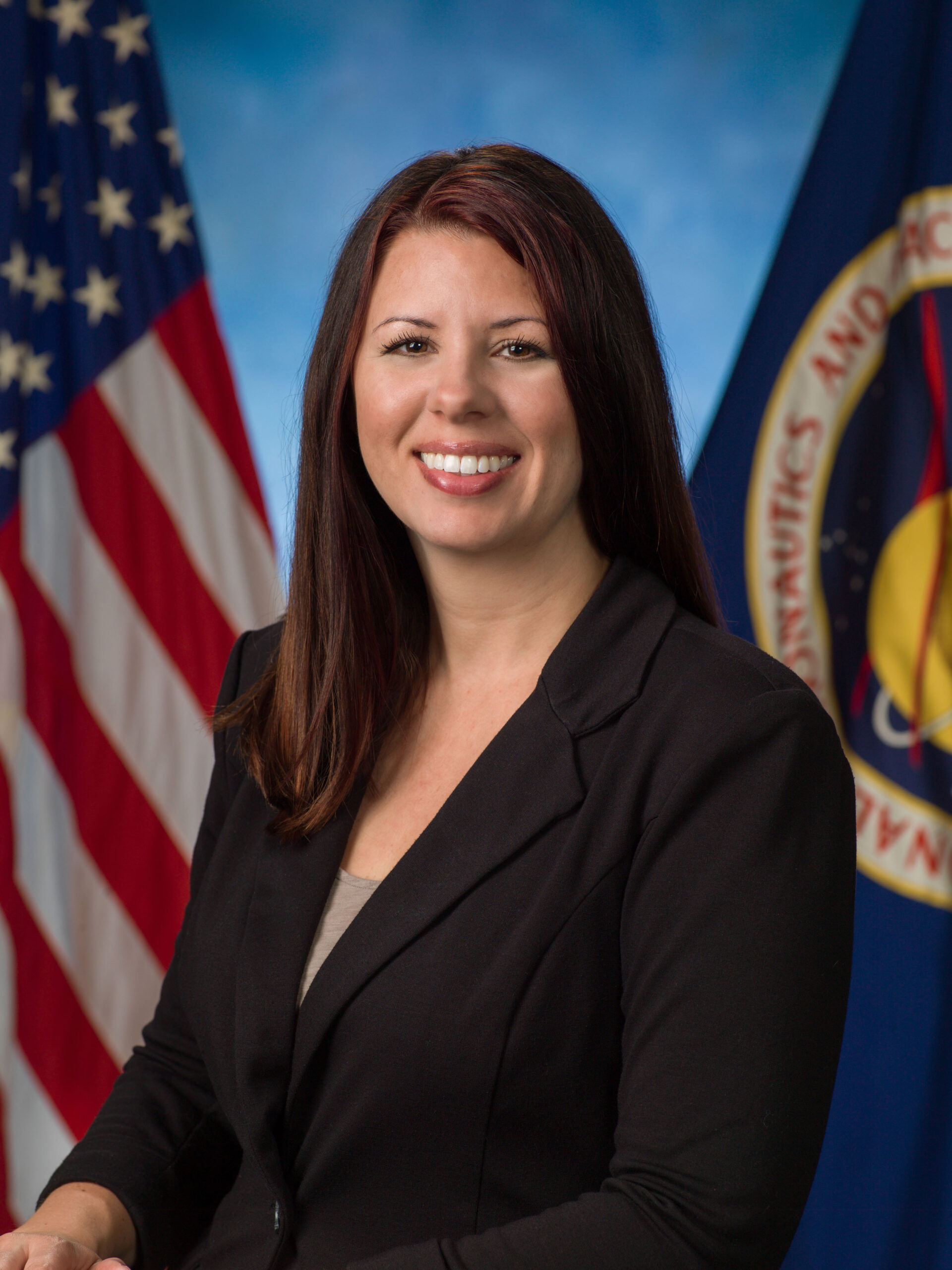 ahenspeter.jpg A woman dressed in a black suit stands in front of a blue background.