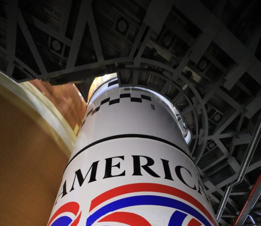 NASA’s Lunar Rocket Marks 250 Years of U.S. Ingenuity Image shows the America 250 logo in black, red, blue colors painted on the white solid rocket boosters of NASA