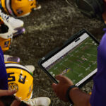 iPad partners with college football, revolutionizing the game. Driving the game forward: iPad teams up with college football