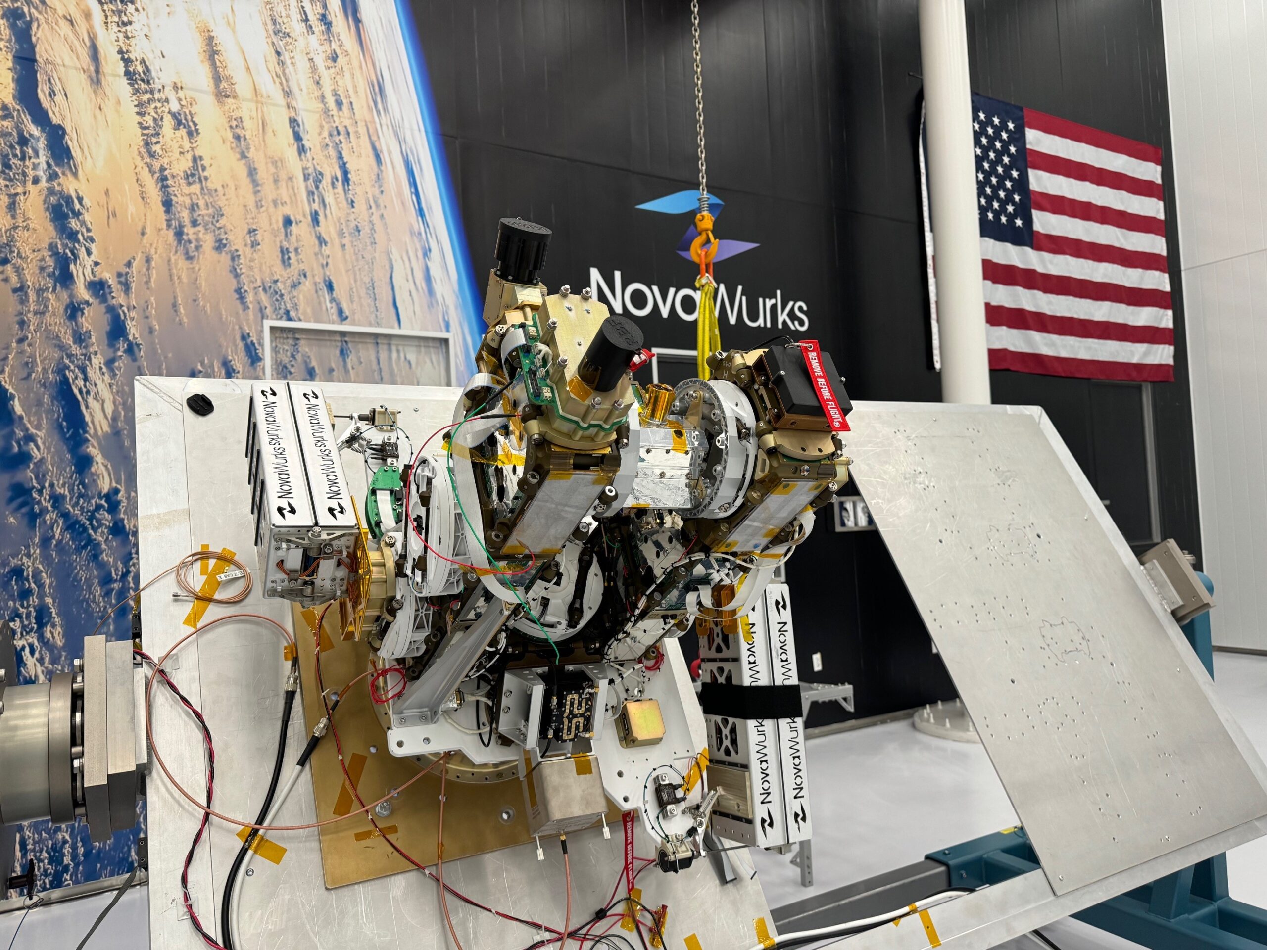 athena tilt w flag 1.jpg Fully integrated, the Athena EPIC satellite undergoes performance testing in a NovaWurks cleanroom to prepare the sensor for launch. The optical module payload element may be seen near the top of the instrument with the single small telescope.