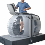 NASA Innovation Enhances Treadmill Experience A man runs on a high tech treadmill, a large bubble-like structure surrounds his lower body