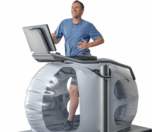 NASA Innovation Enhances Treadmill Experience A man runs on a high tech treadmill, a large bubble-like structure surrounds his lower body