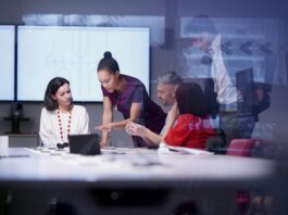 Lenovo Joins EU AI Pact, Pledges Responsible AI Development brand image - Diverse group of a team of co-workers having a meeting in a conference room.