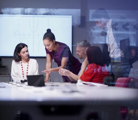 Lenovo 360 Earns 5-Star Rating in 2026 CRN Partner Program Guide brand image - Diverse group of a team of co-workers having a meeting in a conference room.