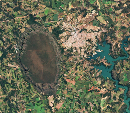 NASA Observes Central Brazil’s Cerrado Ecosystem A dark-green and brown oval-shaped plateau oriented north-to-south is prominent toward the left side of this satellite image of Brazil. A reservoir with branching arms takes up the right side of the image, and a light-colored developed area sits between the plateau and reservoir. A patchwork of irregularly shaped fields surrounds those features.