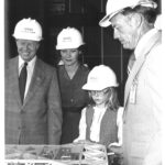 NASA Chief Honors President Carter’s Legacy President Jimmy Carter, wife Rosalynn, daughter Amy, and Kennedy Space Center director Lee Scherer, all wearing NASA hard hats, look down at a scale model of the crawler, which transported the Shuttle to the launch pad. The photo is in black and white.