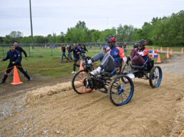 NASA Reveals Competitors for Global Rover Challenge Two students from Team Instituto Tecnologico de Santo Domingo from Santo Domingo, Dominican Republic, pedal their human-powered rover through the 2024 Human Exploration Rover Challenge course. Their teammates cheer them on from outside of the course.