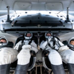 Media Invited to Witness SpaceX Crew-10 Launch to ISS Four NASA SpaceX Crew-10 members sit in a capsule in their white spacesuits, looking around the spacecraft during training.