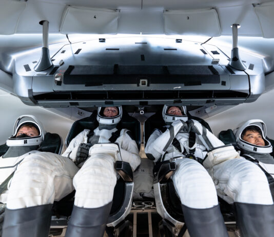 Media Invited to Witness SpaceX Crew-10 Launch to ISS Four NASA SpaceX Crew-10 members sit in a capsule in their white spacesuits, looking around the spacecraft during training.