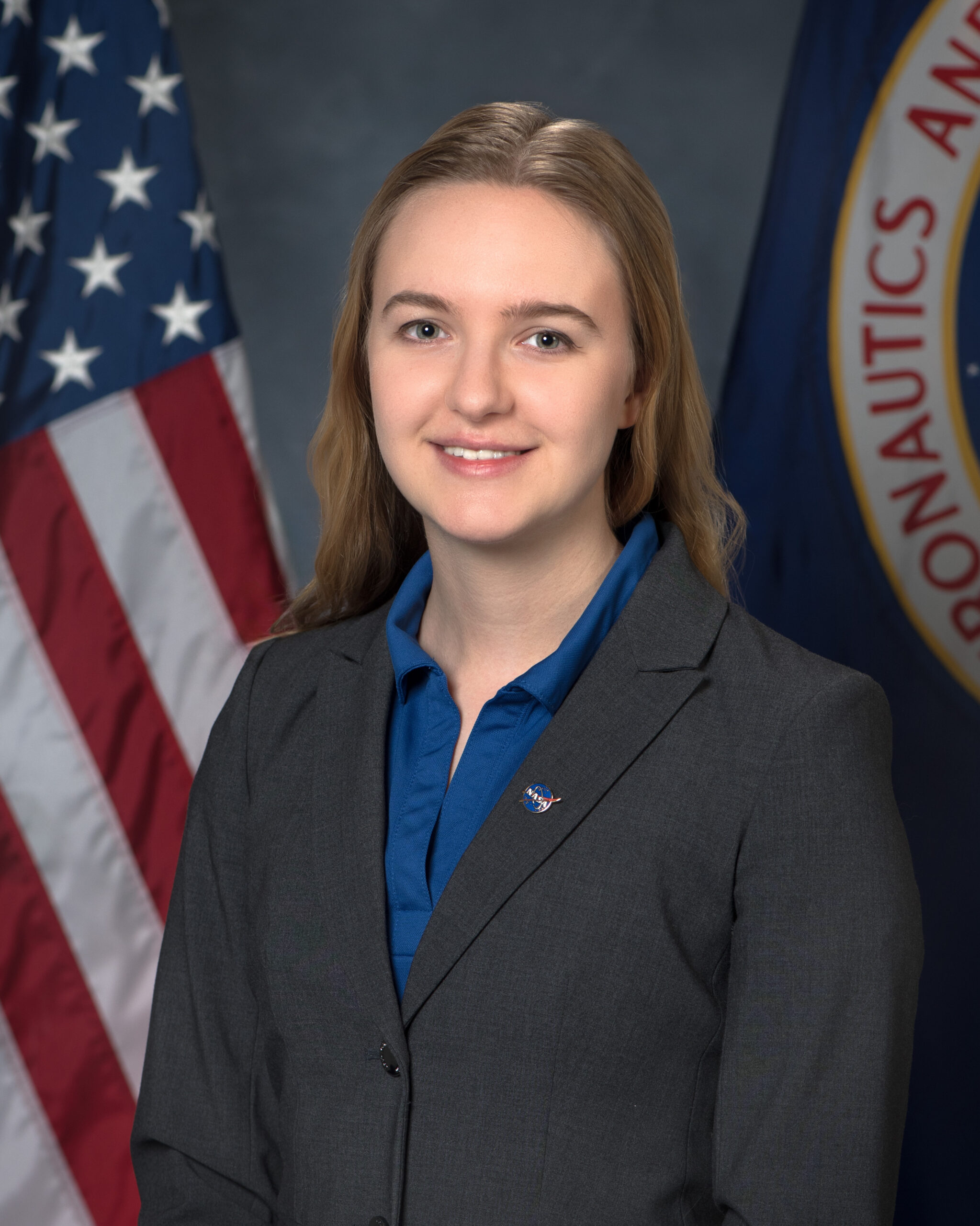 crowell sylvie flag portrait 2025.jpg Portrait of Sylvie Crowell with an American flag and NASA flag partially shown behind her.