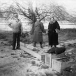 NASA Celebrates a Century of Progress in Rocketry black-and-white photograph of a trio of people standing outdoors with wooden crates at their feet