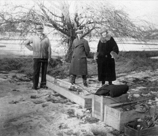 NASA Celebrates a Century of Progress in Rocketry black-and-white photograph of a trio of people standing outdoors with wooden crates at their feet