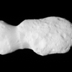 NASA’s Lucy Captures Images of Asteroid Donaldjohanson Gif of Asteroid Donaldjohanson, as seen by the Lucy spacecraft during its close flyby. The asteroid looks like two lobes, attached by a thinner cylinder, like a barbell with very large weights. One lobe is smaller than the other. Although they are both about the same circumference, the smaller lobe is less wide than the other. The asteroid is a smooth, light gray surface, with smooth-edged craters dimpling its surface. The larger lobe has many more craters. The asteroid moves closer to the camera, pushing in on the larger lobe. Then it rotates slightly to look along the asteroid long-ways.