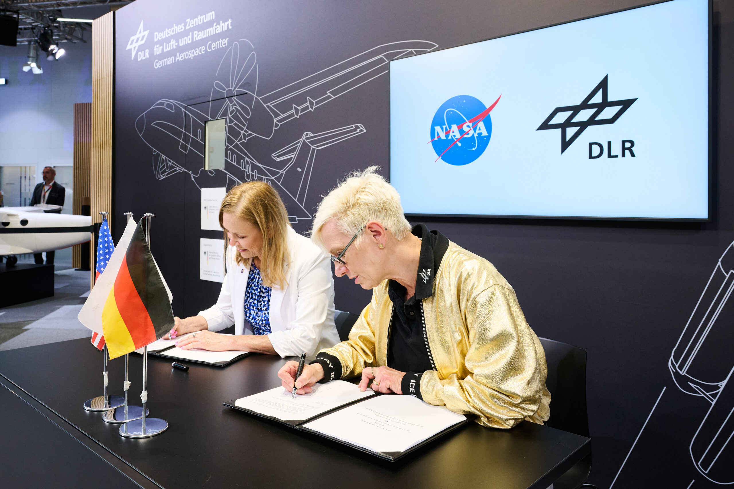 dlr signing for release.jpg NASA acting administrator Janet Petro signs agreement with German Space Agency.