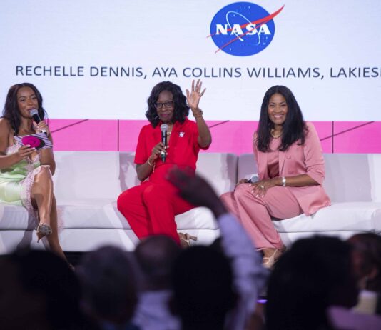 NASA Shines at 2024 ESSENCE Fest in New Orleans A 3-member panelists of women sit on a white sofa to lead Taking Up Space conversation at Essence Fest; The NASA meatball can be seen on the screen in the background