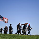 How Community College Students Can Engage with NASA Programs A group male and female students walk along a grassy field in Huntsville, Alabama with a Rocket as part of NASA