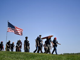 How Community College Students Can Engage with NASA Programs A group male and female students walk along a grassy field in Huntsville, Alabama with a Rocket as part of NASA