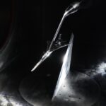 NASA Evaluates the X-59 Aircraft A scaled model of the X-59 experimental aircraft is inside a wind tunnel for testing. All of the visible surfaces and the plane are a metallic silver. The aircraft has a distinctive long nose with a curved end. A spotlight on the floor in the far corner lights up the scene.