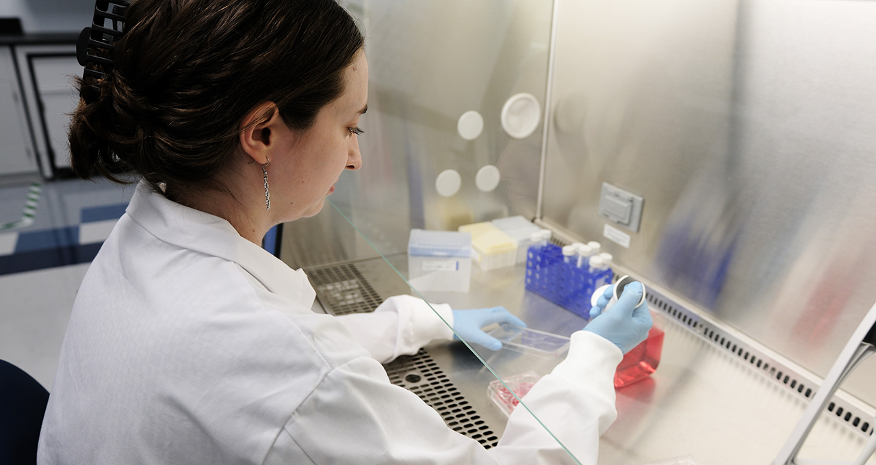 woman in a lab coat conducting research