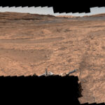 NASA’s Perseverance and Curiosity Showcase Stunning Mars Panoramas A series of shallow, sand-filled pits with low ridges spread across a tawny Martian landscape. Rover tracks stretch toward the horizon at left, and steep ridgetops loom in the background.
